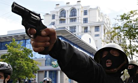 A pro-Russian activist aims a pistol at supporters of the Kiev government during clashes in Odessa